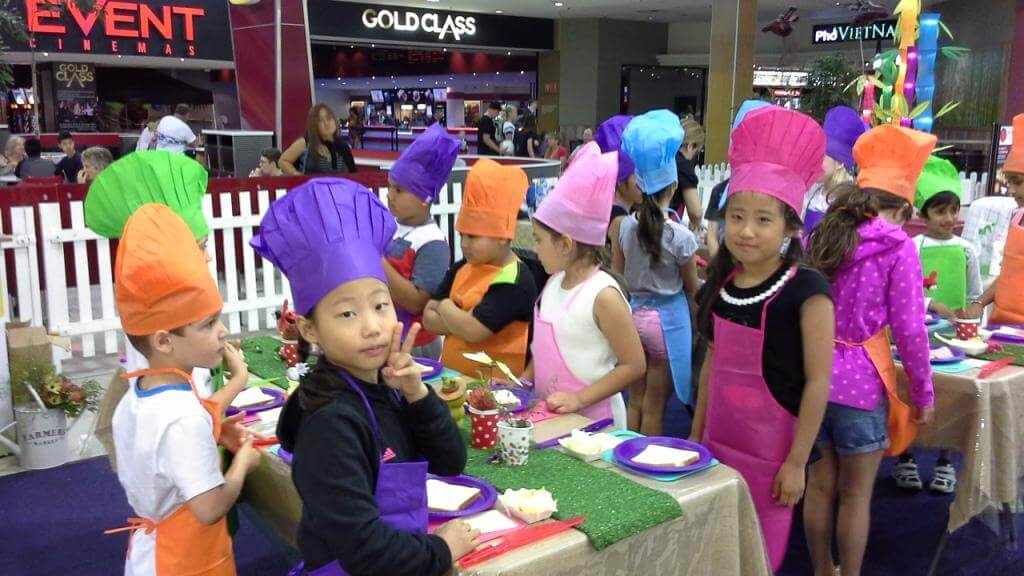 Kids attending cooking class activity while studying English in Australia at AICOL